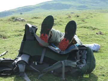 hiker's shoes propped up on his pack