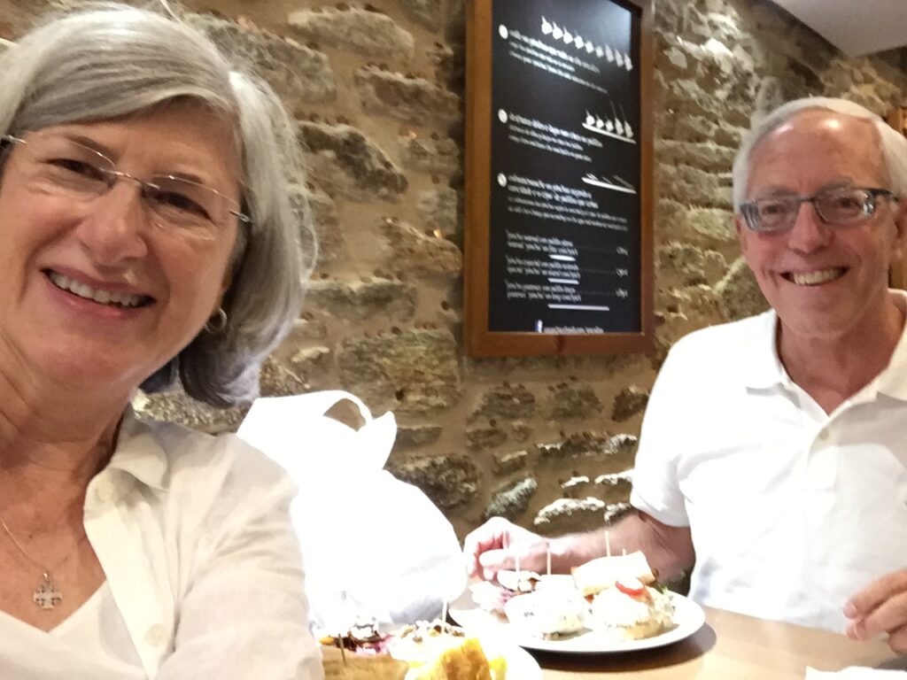 Helen and Wick eating tapas at Antollo's bar as a way to enjoy Santiago