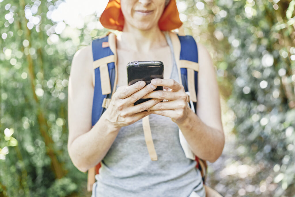 woman hiker consulting her smart phone