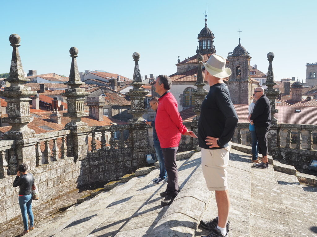 two men standing on the roof of the Cathedral of St. James to enjoy Santiago from a high view