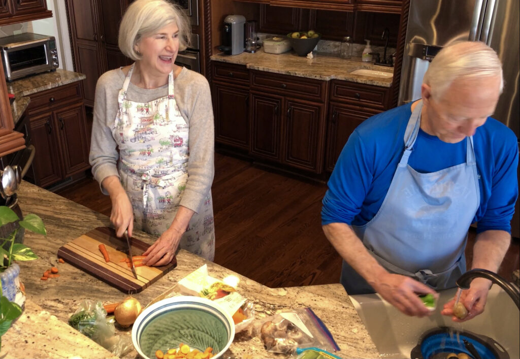 Helen and Wick in the kitchen with carrots for the Camino Chicken Vegetable Soup