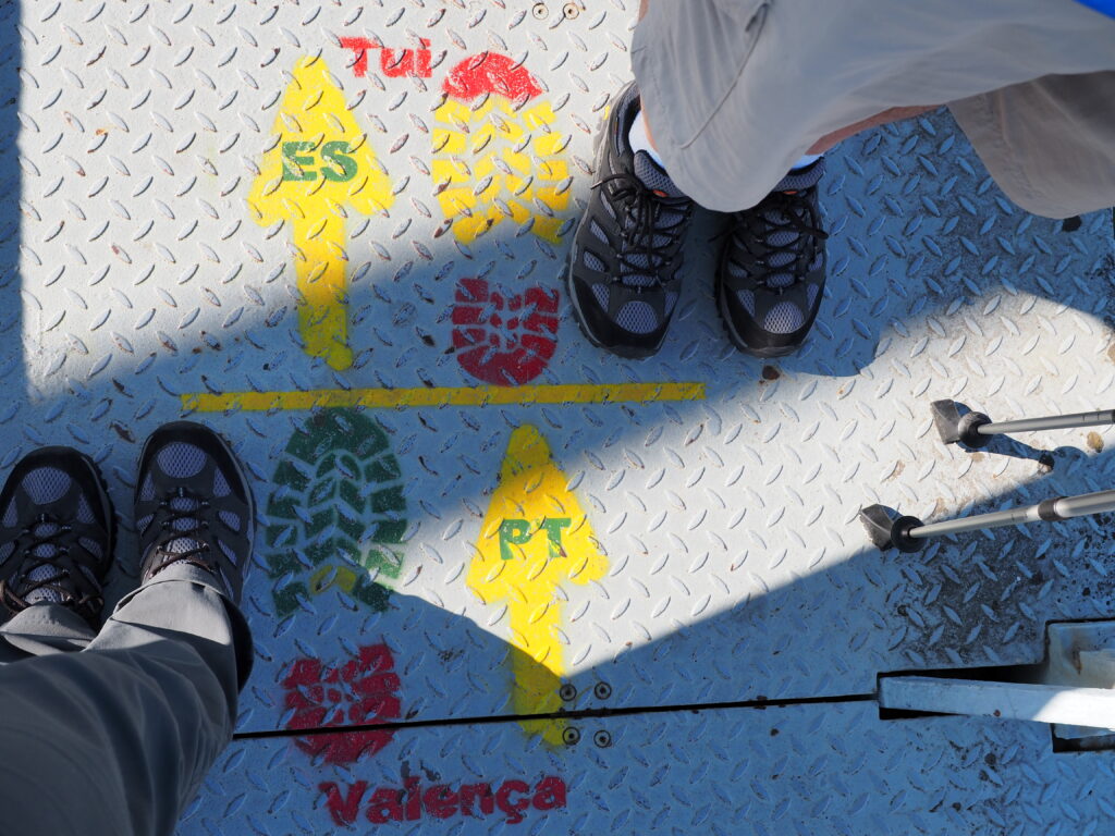 two pairs of hiking shoes face each other on the Caminho Portugués path