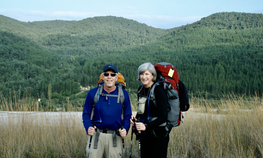 Helen and Wick walking the Camino with heavy backpacks