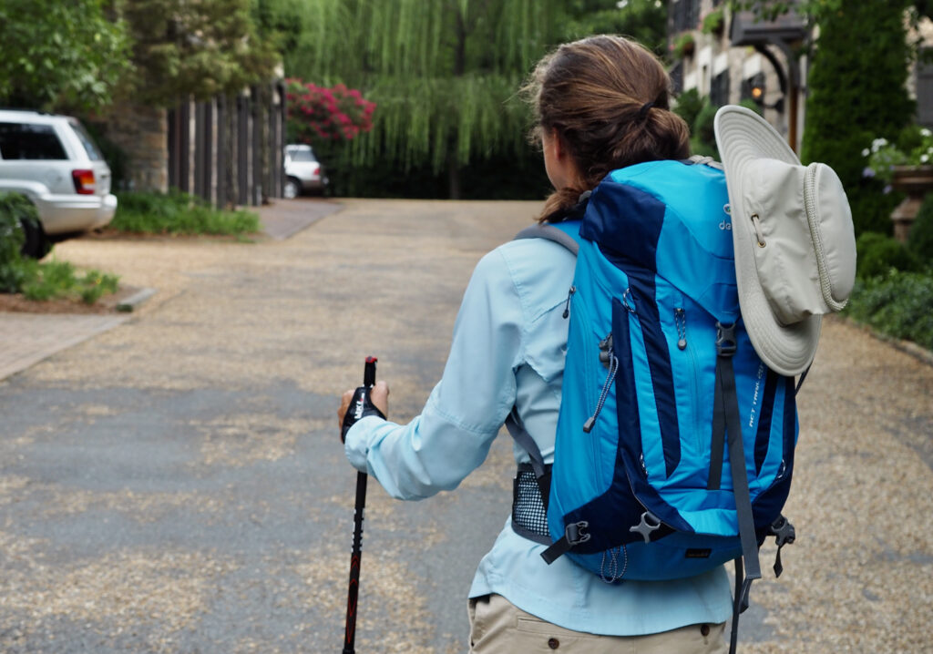 woman in hiking clothes with turquoise backpack