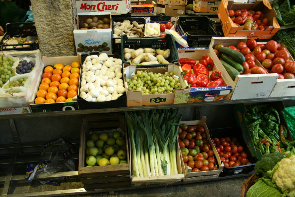 Fruits and vegetables on display at a stall in the Mercado de Abastos