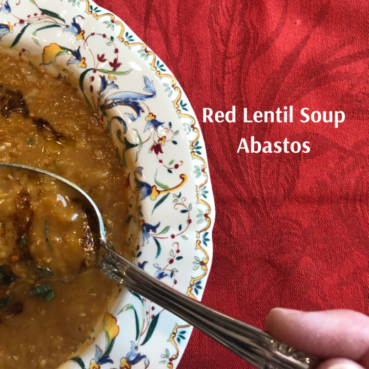 a bowl of Red Lentil Soup Abastos on a red tablecloth with spoon