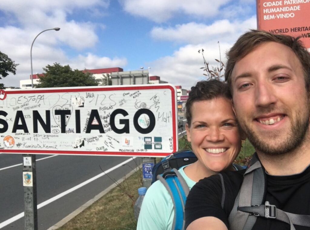 Hunter and Stephie Van Wagenen in hiking clothes in front of Santiago street sign