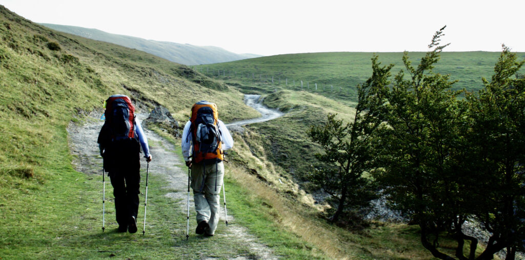 Wick and Helen making a steep ascent in the Pyrenees with their packs on