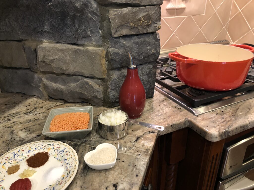 stove with orange soup pot and ingredients for the Red Lentil Soup Abastos