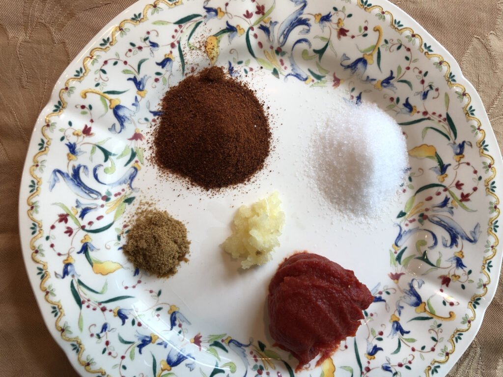 small decorative plate with little piles of spices and tomato paste