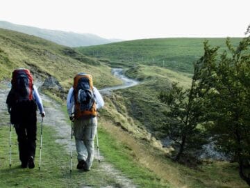 couple walking with backpacks on the Camino de Santiago