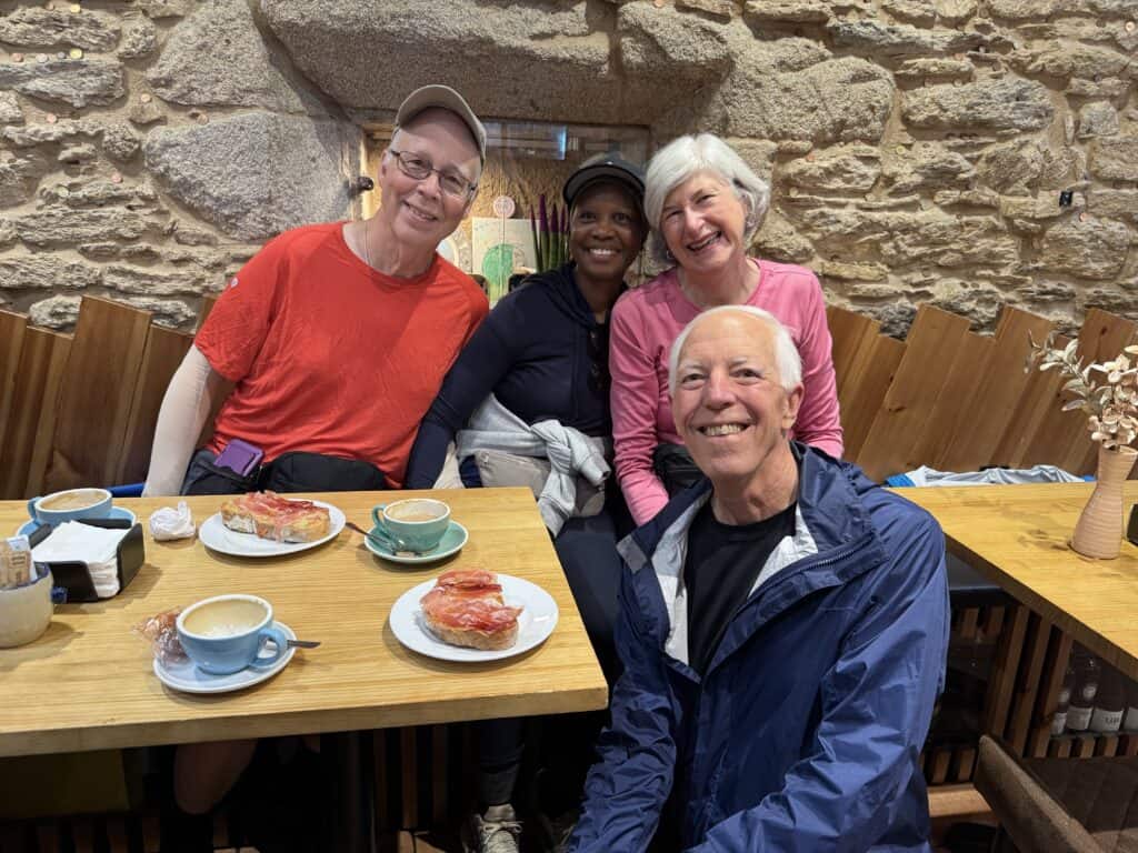 four people meet at a café fro breakfast